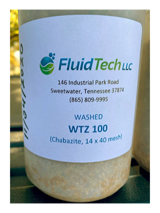 Labeled sample jar of washed WTZ 100 chabazite zeolite, 14 x 40 mesh