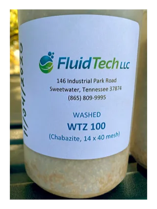Labeled sample jar of washed WTZ 100 chabazite zeolite, 14 x 40 mesh